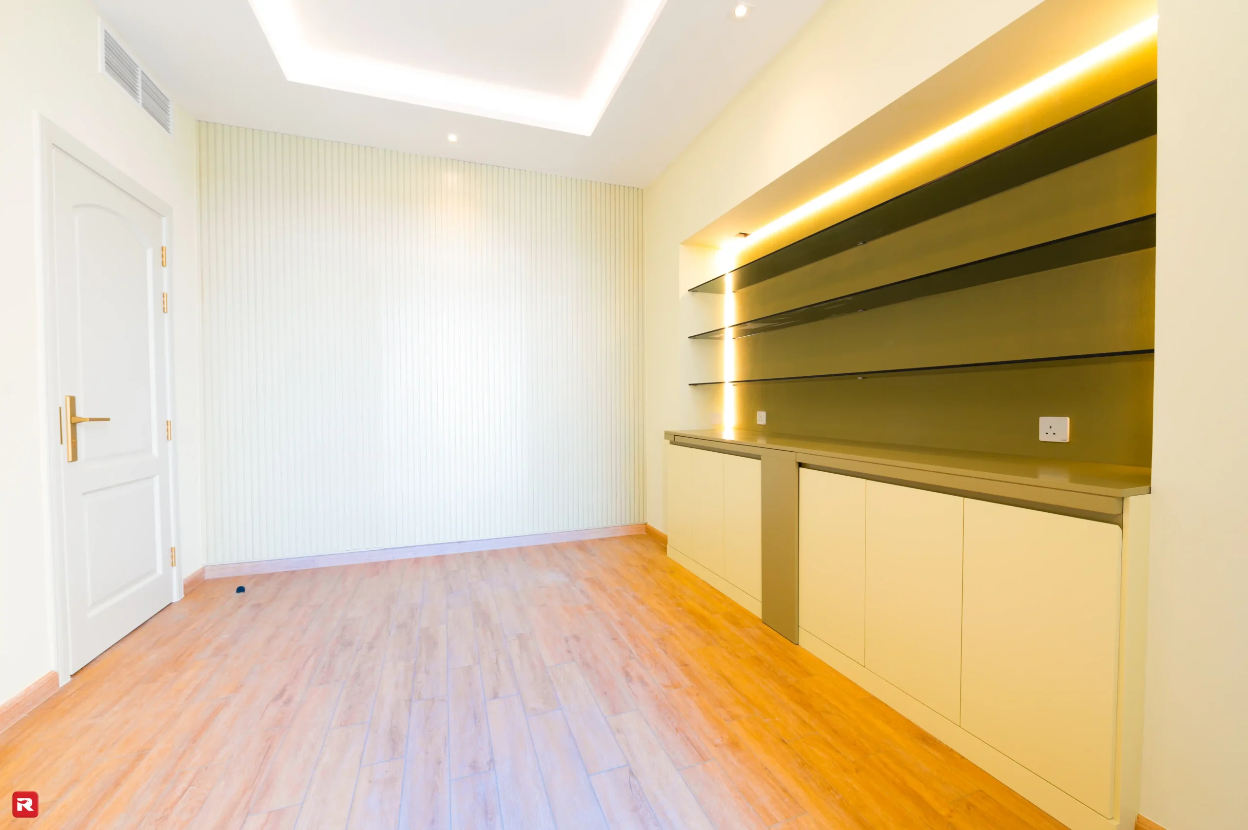 Contemporary study room with built-in cabinets and open shelves at a villa in Al Furjan by RCi-Red Chillies Interiors